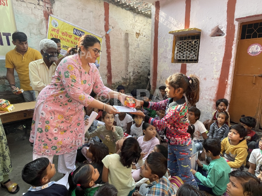 Dr. Gunita Singh with kids of coolie camp