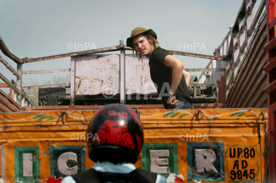Foreign tourist travels on a truck in India