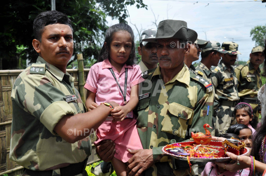 Indian girl tying Rakhi to BSF Jawans