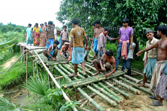 Villagers making a bridge with bamboo